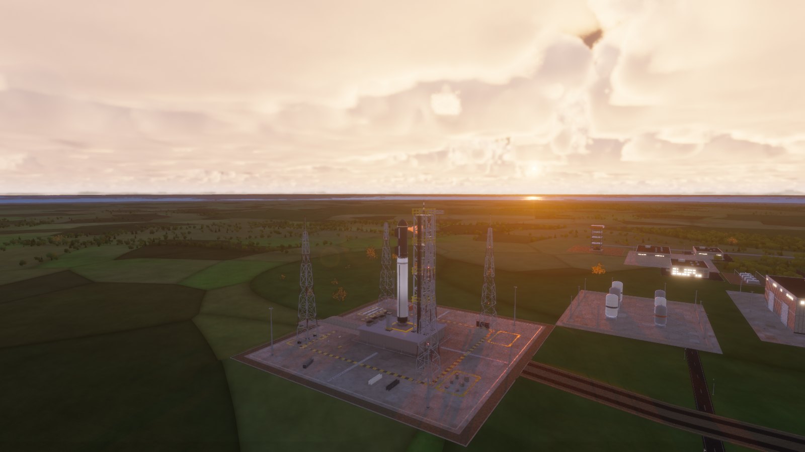 A super-heavy rocket on the launch pad at sunset, the space center campus around it